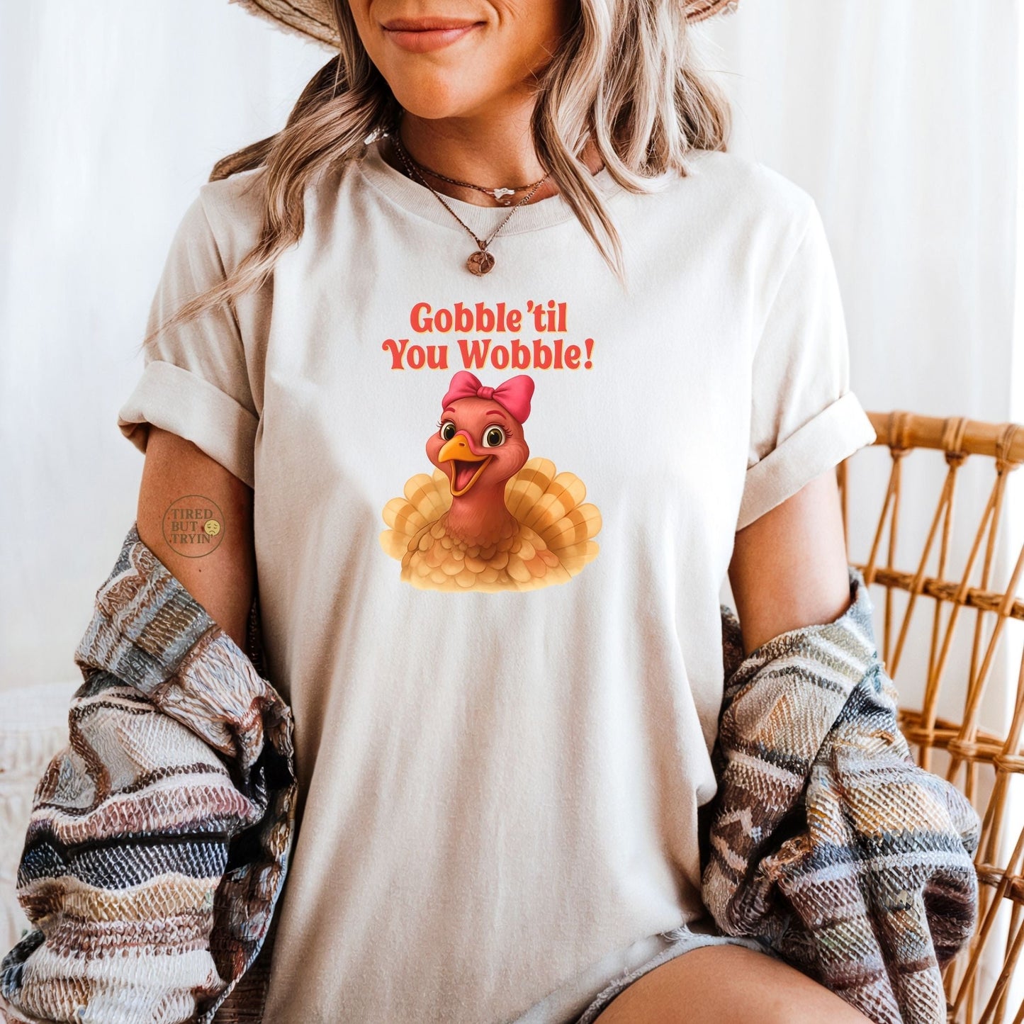 Gobble ’Til You Wobble Turkey Shirt – Funny Thanksgiving Tee, Smiling Female Turkey with Coquette Bow, Friendsgiving Graphic Top - Sand