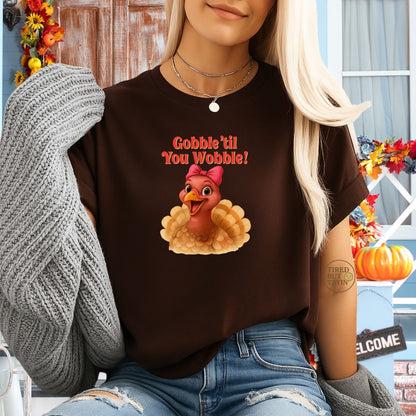 Gobble ’Til You Wobble Turkey Shirt – Funny Thanksgiving Tee, Smiling Female Turkey with Coquette Bow, Friendsgiving Graphic Top - Dark Chocolate