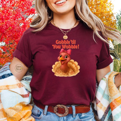 Gobble ’Til You Wobble Turkey Shirt – Funny Thanksgiving Tee, Smiling Female Turkey with Coquette Bow, Friendsgiving Graphic Top - Maroon