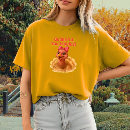 Gobble ’Til You Wobble Turkey Shirt – Funny Thanksgiving Tee, Smiling Female Turkey with Coquette Bow, Friendsgiving Graphic Top - Gold
